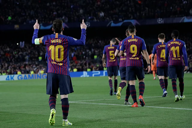 Barcelona’s Lionel Messi, left, celebrates after scoring his side’s third goal during the Champions League round of 16, 2nd leg, soccer match between FC Barcelona and Olympique Lyon at the Camp Nou stadium in Barcelona, Spain.