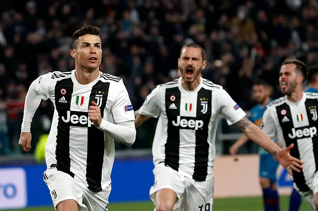 Juventus’ Cristiano Ronaldo, left, celebrates after scoring his side’s third goal during the Champions League round of 16, 2nd leg, soccer match.