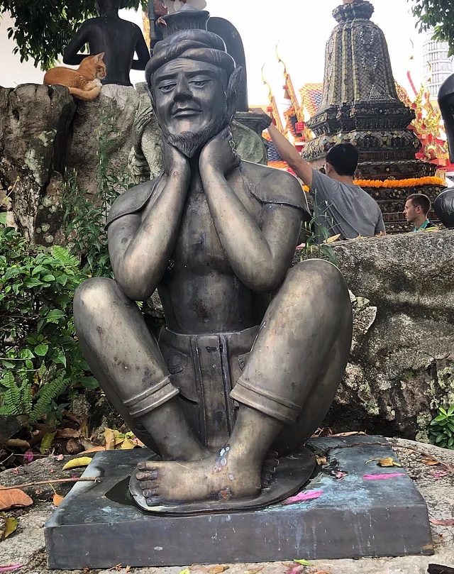 Statuette at the ‘Wat of Emerald Buddha’ is used to represent the author’s reluctant partner-in-crime.