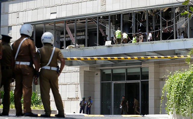 Police and forensic officials inspect a blast spot at the Shangri-la hotel in Colombo.