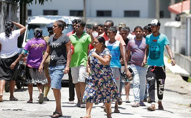 Relatives gather outside a hospital following the blasts in Colombo.