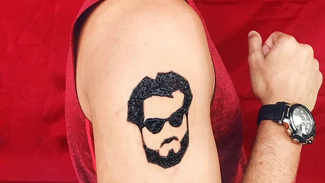 Man flaunting his biceps with a Rajinikanth inspired mehendi on it