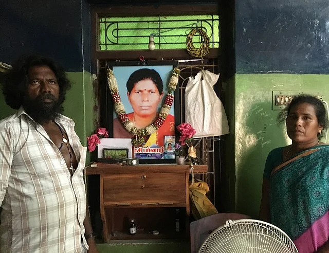 Jesu Balan and Arokiamary in front of a photo of Jhansi who was killed in the firing.