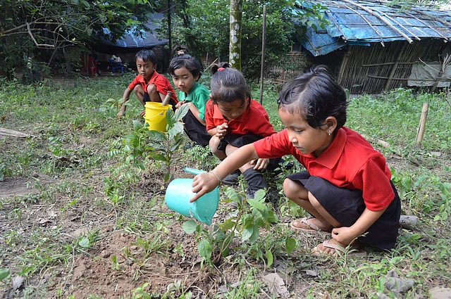 Students planting trees at Akshar School. 