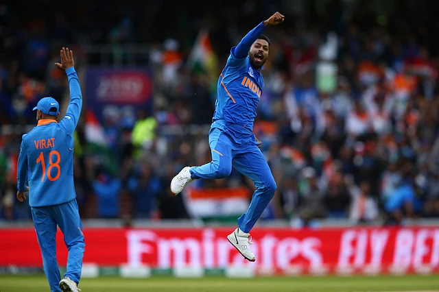 India's Hardik Pandya, right, celebrates taking the wicket of Pakistan's Shoaib Malik during the Cricket World Cup.