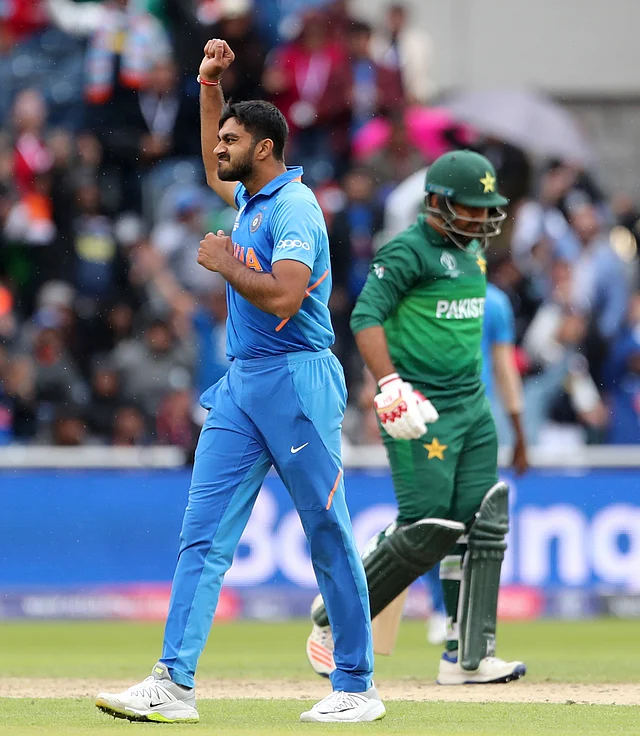 India's Vijay Shankar, left, celebrates the dismissal of Pakistan's captain Sarfaraz Ahmed, right, during the Cricket World Cup.