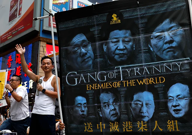Protesters march with witty banners along a downtown street, speaking out against the proposed amendments to Hong Kong’s extradition law. 