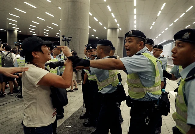 Police officers clash with protesters in a rally against the proposed amendments to the extradition law at the Legislative Council in Hong Kong during the early hours of Monday, 10 June.