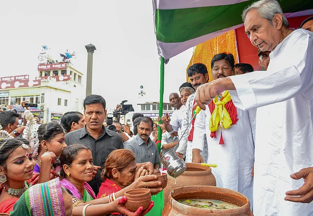 Odisha Chief Minister Naveen Patnaik distributes Abhada Torani to devotees during the annual Rath Yatra in Puri.