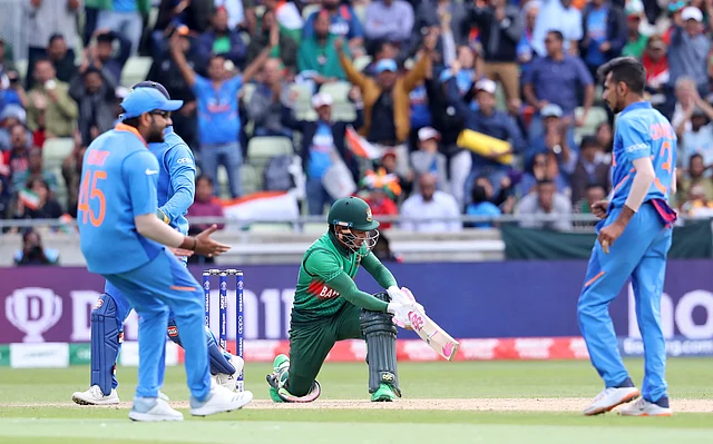 Indian cricketers celebrate the dismissal of Bangladesh’s Mushfiqur Rahim , center, during the Cricket World Cup match between India and Bangladesh.