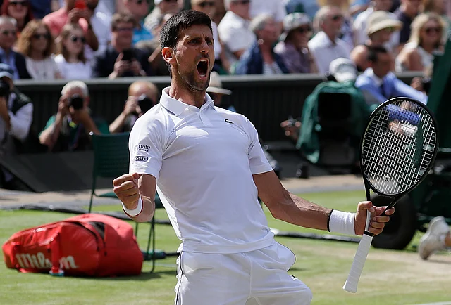 Novak Djokovic celebrates after beating Spain’s Roberto Bautista Agut in a Men’s singles semifinal match of the Wimbledon.
