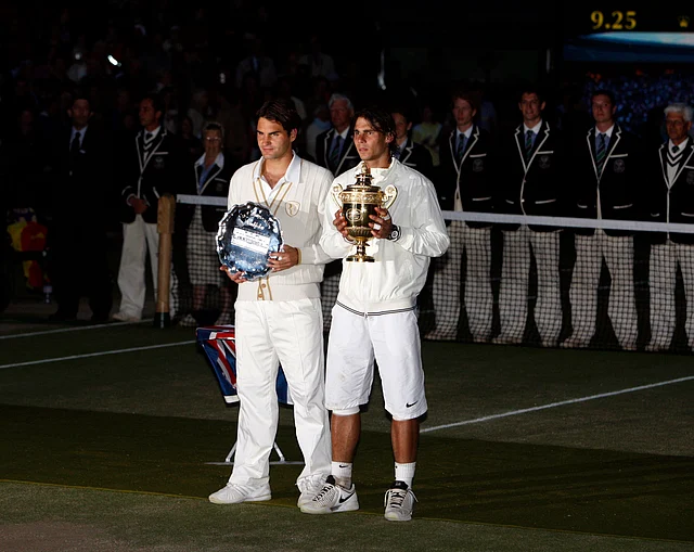 File photo from 2008. Rafael Nadal stands with the winners trophy next to Switzerland’s Roger Federer. 