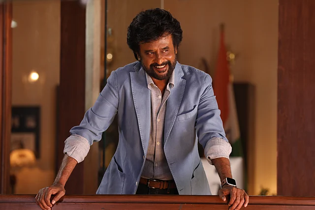 A stylish Rajinikanth in a sky blue blazer.