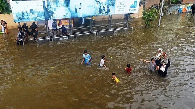 Kids playing in the massively waterlogged area of King’s Circle.