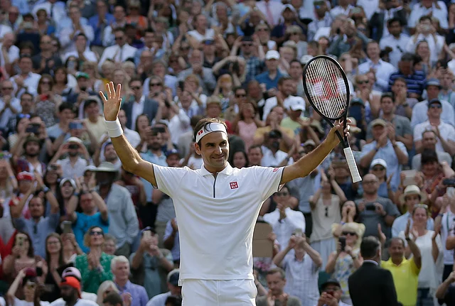 Switzerland’s Roger Federer celebrates defeating Japan’s Kei Nishikori during a men’s quarterfinal match on day nine of the Wimbledon Tennis Championships.