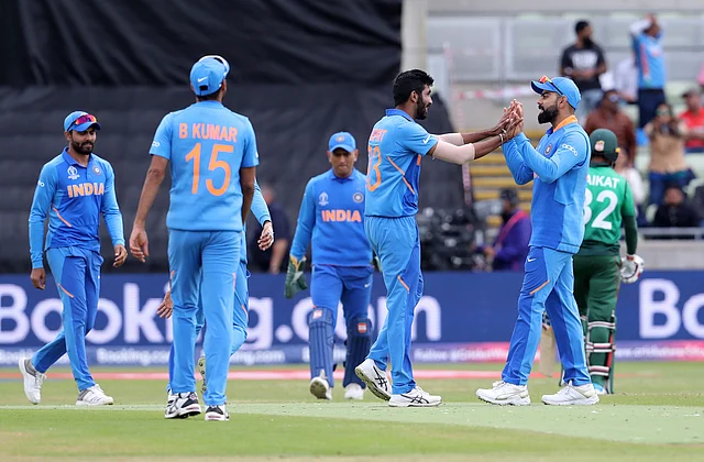 India’s Jasprit Bumrah, without cap, celebrates with India’s captain Virat Kohli after dismissing Bangladesh’s Mosaddek Hossain during the Cricket World Cup match.