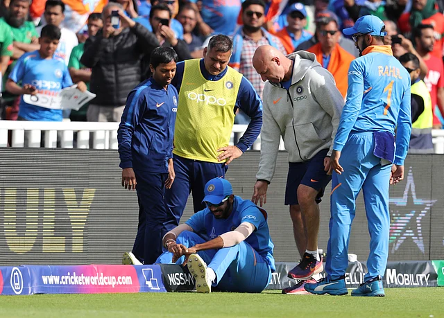 India’s Jasprit Bumrah receives treatment after an injury while fielding during the Cricket World Cup match.