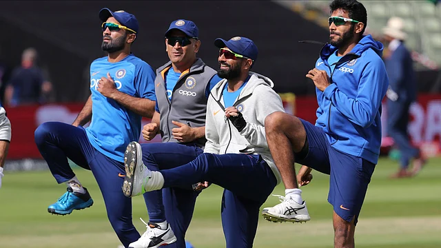 Dinesh Karthik warms up with his team-mates ahead of the match against Bangladesh.