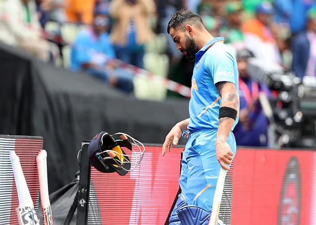 India’s captain Virat Kohli throws his helmet as he leaves the ground after being dismissed by Bangladesh’s Mustafizur Rahman during the Cricket World Cup match between Bangladesh and India.