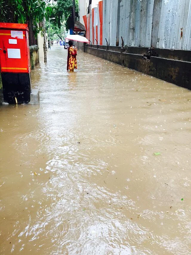 A woman stuck in the waterlogged street.