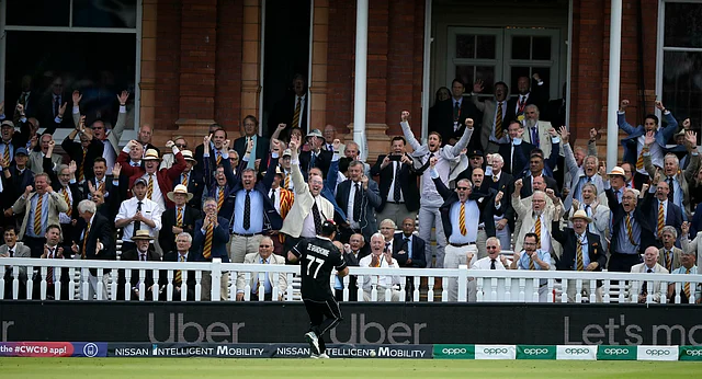 MCC members celebrate after England’s Ben Stokes got a boundary from overthrows after the ball hit his helmet during the Cricket World Cup final match between England and New Zealand at Lord’s cricket ground in London.