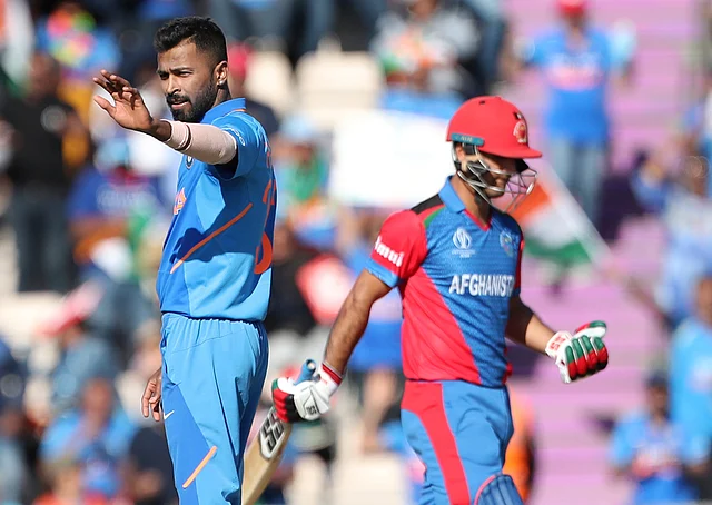 India’s Hardik Pandya, left, celebrates the dismissal of Afghanistan’s Najibullah Zadran, right, during the Cricket World Cup match.