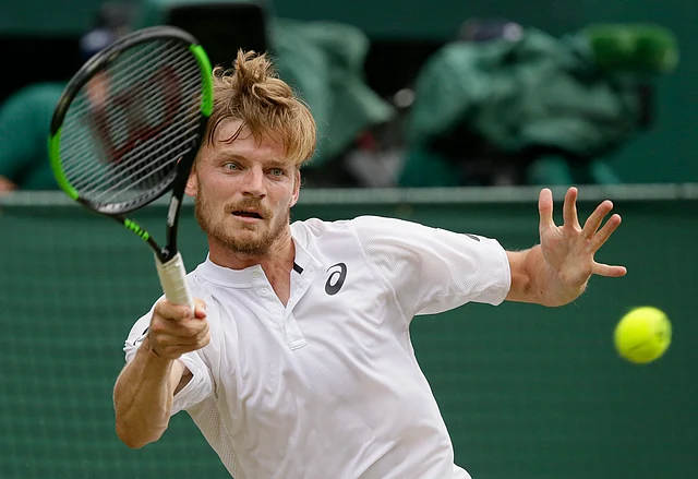 Belgium’s David Goffin returns the ball to Serbia’s Novak Djokovic during a men’s quarterfinal match on day nine of the Wimbledon Tennis Championships.