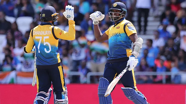 Sri Lanka’s Angelo Mathews (right) celebrates with teammate Dhananjaya de Silva after scoring a century during the Cricket World Cup match.