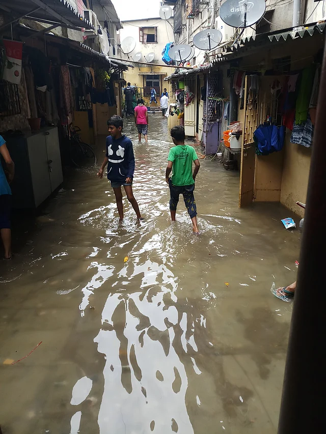 Kids struggling with the water-logging in Kurla.