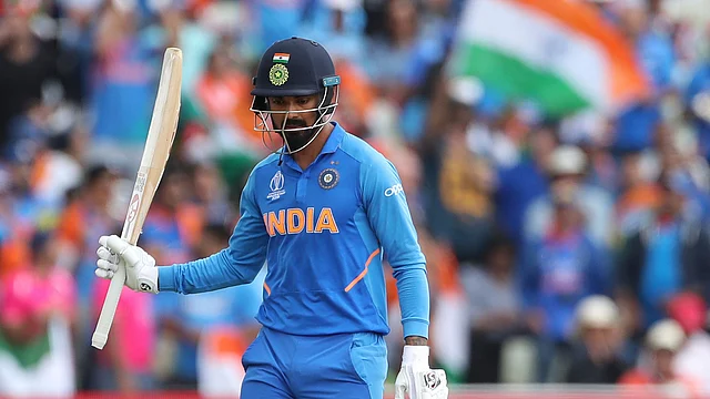 India’s K.L. Rahul raises his bat to celebrate scoring fifty runs during the Cricket World Cup match between Bangladesh and India at Edgbaston.