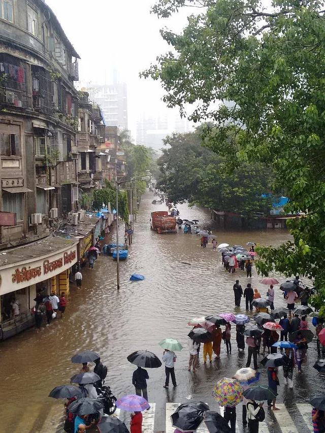 People trying to find their way through the waterlogged area.