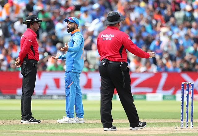 India’s captain Virat Kohli, center, interacts with umpire Marais Erasmus, left, after losing a review of Bangladesh’s Soumya Sarkar during the Cricket World Cup match.
