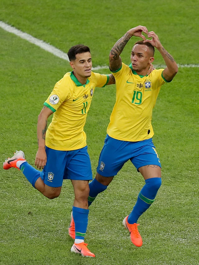 Brazil’s Everton celebrates scoring his side’s opening goal against Peru with Phlippe Coutinho during the final football match of the Copa America.