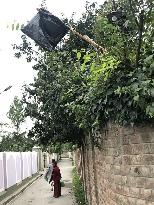 Black flags hoisted outside houses to express resistance. 