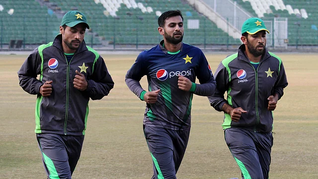Shoaib Malik runs with Mohammad Amir and Shoaib Maqsood during a Pakistan training camp where Amir was making a comeback after serving a five-year ban.