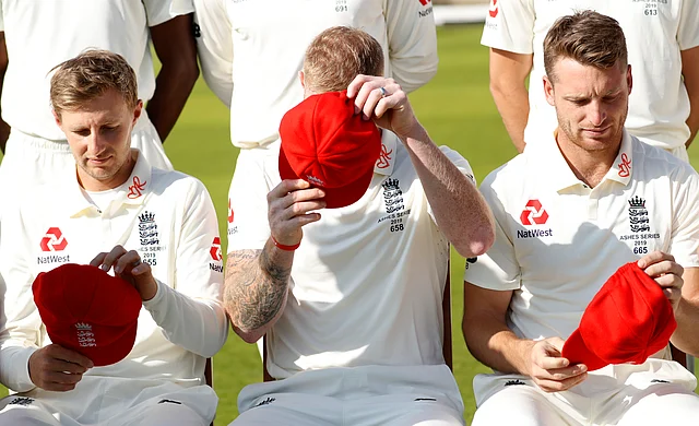 England’s Joe Root, left, Ben Stokes, centre and Jos Buttler put on their official caps as they pose for the cameras at Lord’s cricket ground.