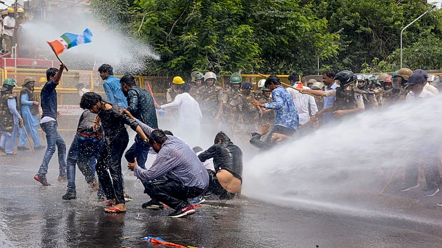 Policemen use water cannons to disperse the Youth Congress activists during a protest, in Jabalpur on Wednesday, 7 August.