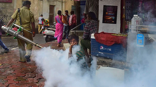 A BMC worker carries out fumigation works as a part of preventive measures against malaria, in Mumbai on Wednesday, 7 August. 