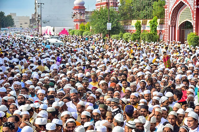 Muslims gather to offer Eid al-Adha prayers at Eidgah Shahjamal, in Aligarh, Monday