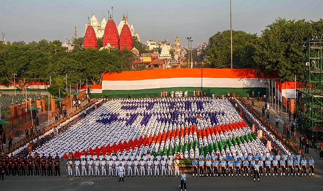 School children make a tricolour during a rehearsal for the 73rd Independence Day function at the historic Red Fort.