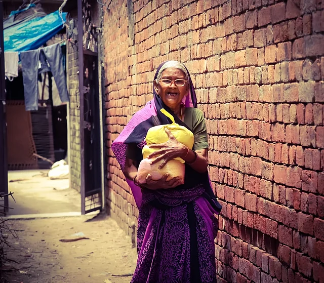 An elderly woman in UP’s Baniyan Purwa village, with a packet of rations distributed by Robins from Kanpur.