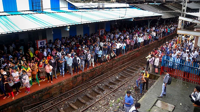 Passenger stranded at Thane railway station after heavy monsoon rains hit the local train services on Monday, 5 August. 