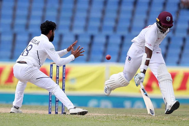 West Indies’ Miguel Cummins makes it safely to his ground before India’s Ravindra Jadeja receives the ball during day three of the first Test.