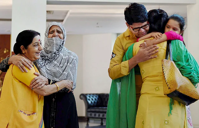 Uzma Ahmed, an Indian citizen who was forcefully married off to a Pakistani man, was brought back to India by Swaraj in 2017. In this photo, clicked on 25 May 2017, Swaraj, who was external affairs minister then, looks on with a smile while Ahmed gets emotional while uniting with her family during a press conference at Jawahar Bhawan in New Delhi. 