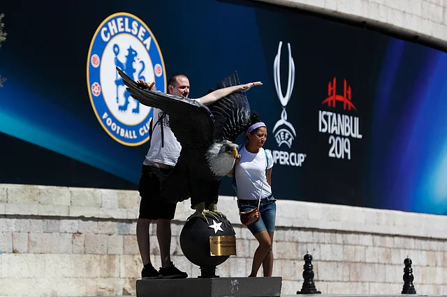 Tourists pose for photos outside Besiktas Park in Istanbul ahead of the UEFA Super Cup soccer match between Liverpool and Chelsea.