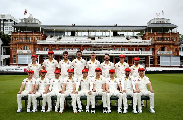Australian cricket team pose for a photograph some wearing red caps, which will be worn on day two of the second Test in aid of the Ruth Strauss Foundation.