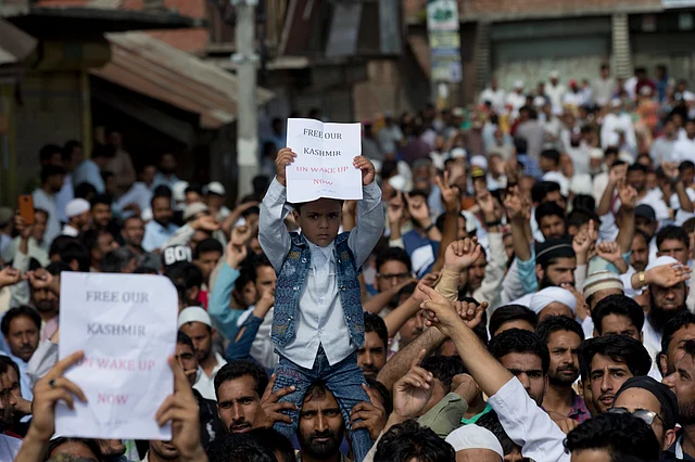 A child holds a placard during a protest in Srinagar.