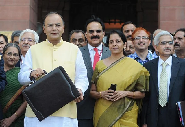 Then Finance Minister Arun Jaitley poses with the customary suitcase before presenting his maiden budget in 2014.