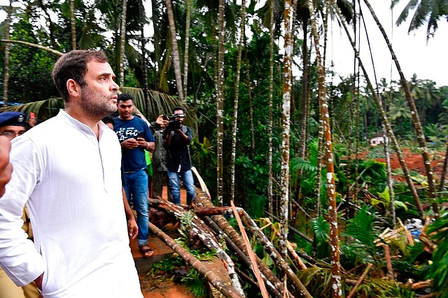 Congress leader Rahul Gandhi, left, visits a landslide site in Kavalappara, Malappuram district of Kerala on 11 August 2019.