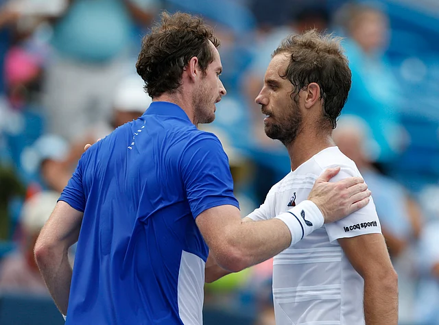 Andy Murray, of Great Britain, congratulates Richard Gasquet, of France, on his win during first round play at the Western & Southern Open tennis tournament, Monday, Aug. 12, 2019, in Mason, Ohio.